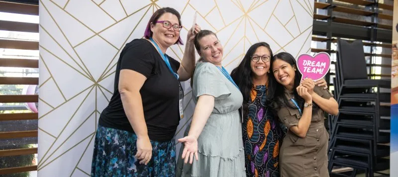 A group of women pose for a photo