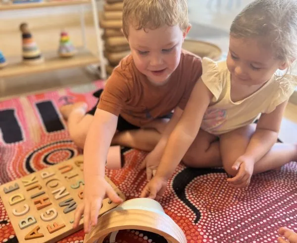 Two children playing with blocks