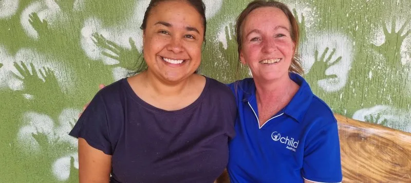 2 women smile for a photo