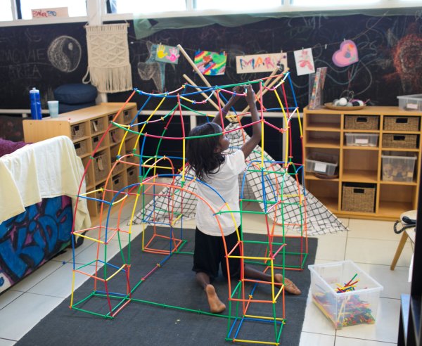A child building a fort with blocks