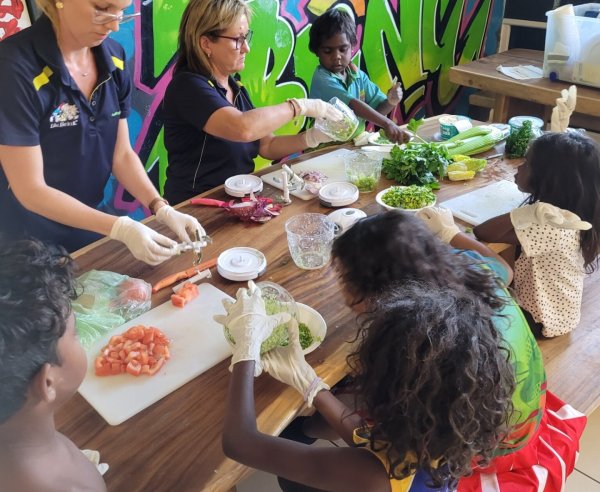 Educators teaching children how to cook and live a healthy lifestyle