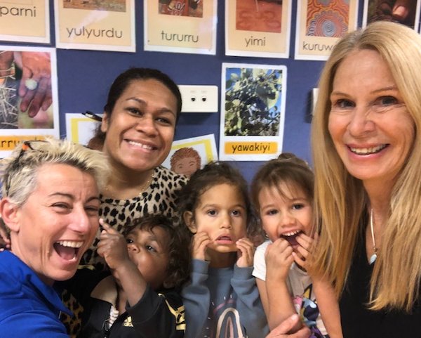 3 Child Australia staff members and 3 kids smiling and laughing for a photo