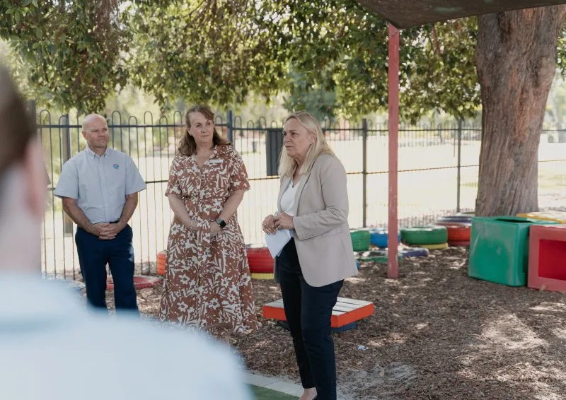 2 women and a man discuss the grant program outside