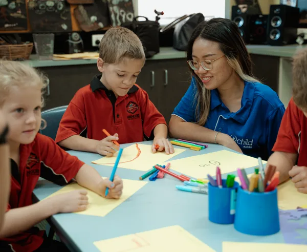 Children colouring in their drawings together