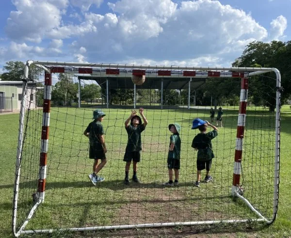 Children outside, playing soccer